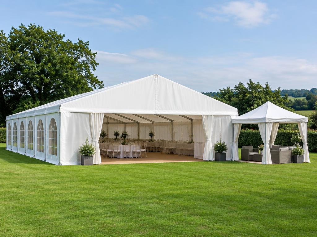 White marquee and gazebo set up on a lawn